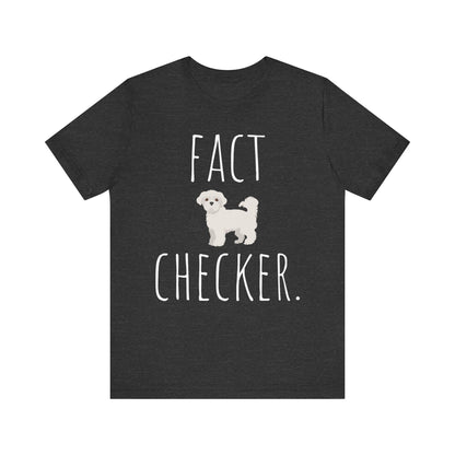 "Fact Checker" Maltese Dog T-Shirt for Unisex with a cute graphic of a Maltese dog and playful "Fact Checker" text underneath. Ideal for dog lovers. Ideal for dog lovers with a sense of humor. Available in multiple colors and sizes. Bella+Canvas 3001 t-shirt in dark grey heather. ReadyShirtAim.com