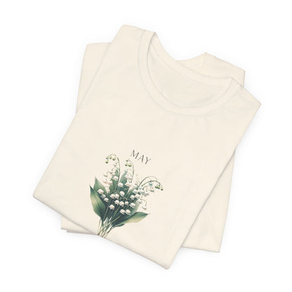 A t-shirt featuring a beautiful Lily of the Valley for May with traits Motherhood, Sweetness, Purity. Perfect for May birthdays and floral art lovers. Comfortable and stylish for casual outings or celebrations. Bella+Canvas 3001 t-shirt in natural. ReadyShirtAim.com