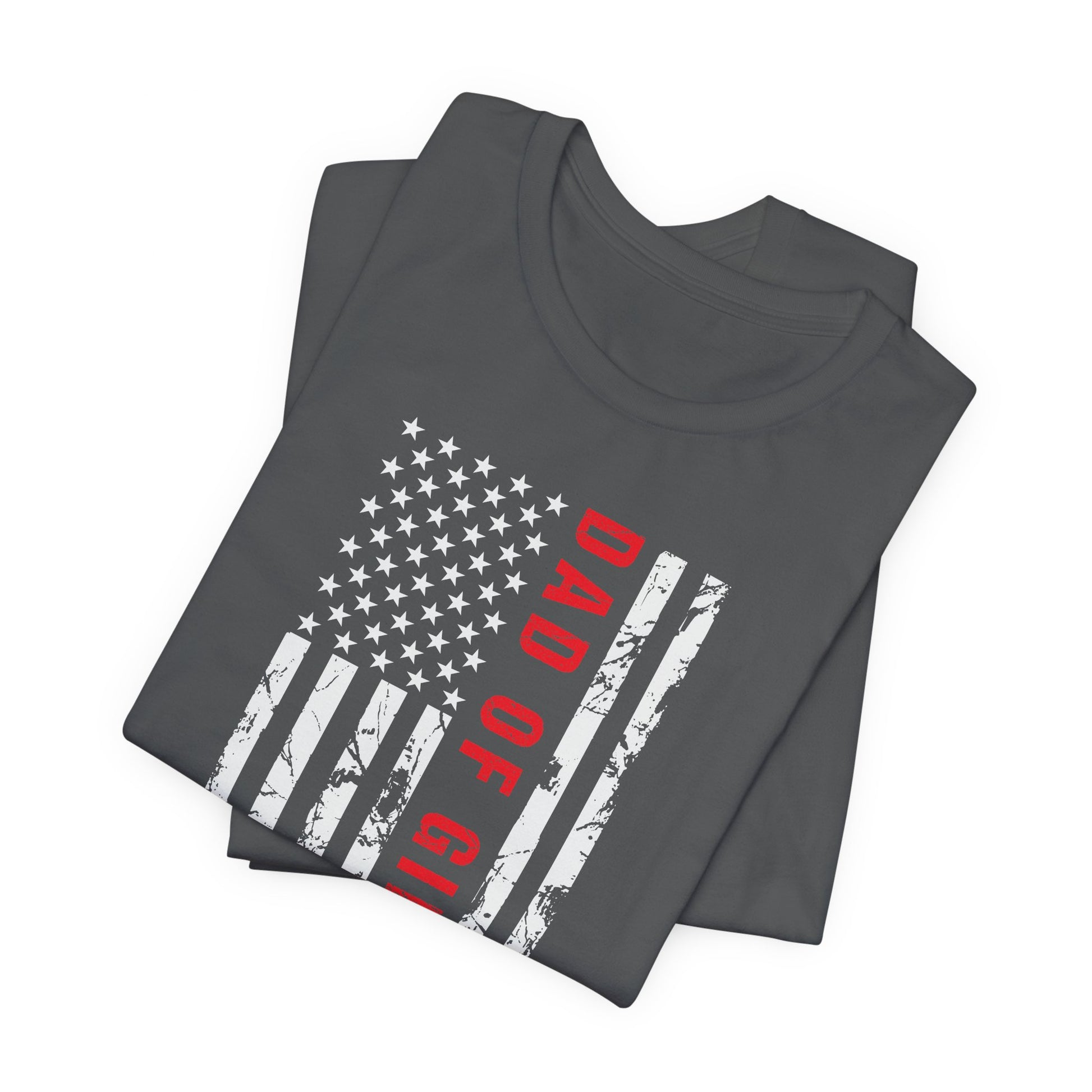 A dark-colored t-shirt featuring a grungy American flag design with the text "Dad of girls #outnumbered" in white and red. Perfect for Father's Day, Fourth of July, and patriotic dads who love humor. Comfortable and stylish for casual wear. Bella+Canvas 3001 t-shirt in asphalt. ReadyShirtAim.com