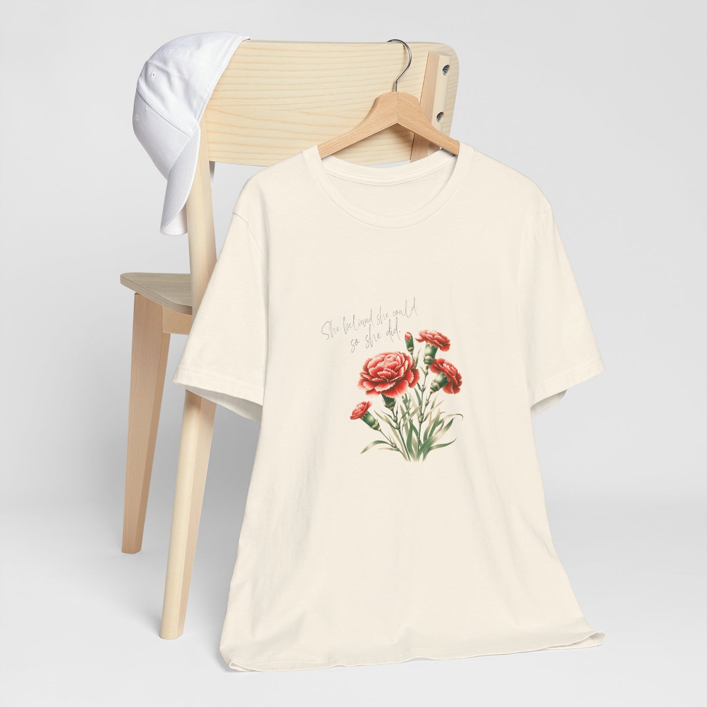 A t-shirt featuring a beautiful carnation for January with the quote “She believed she could, so she did.” Perfect for January birthdays and floral art lovers. Comfortable and stylish for casual outings or celebrations. Bella+Canvas 3001 t-shirt in natural. ReadyShirtAim.com