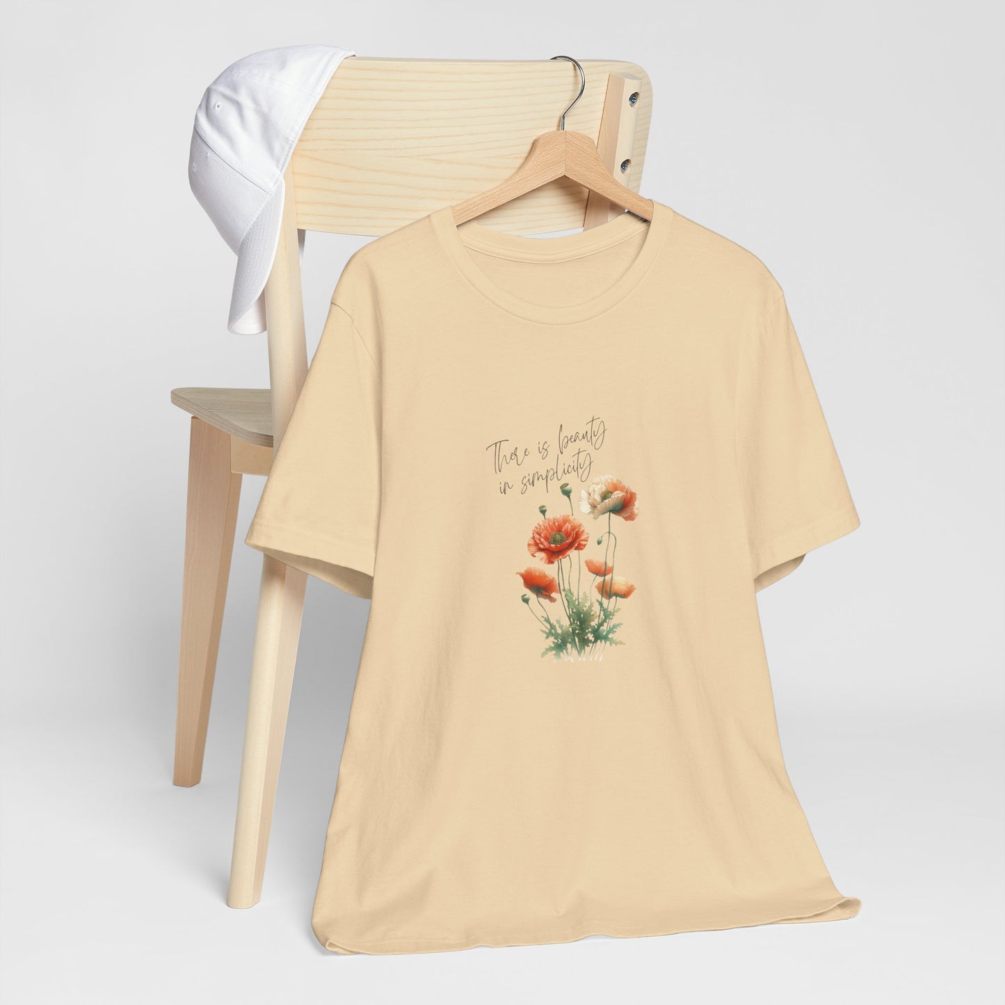 A t-shirt featuring a beautiful poppy for August with the quote “There is beauty in simplicity.” Perfect for August birthdays and floral art lovers. Comfortable and stylish for casual outings or celebrations. Bella+Canvas 3001 t-shirt in soft cream. ReadyShirtAim.com