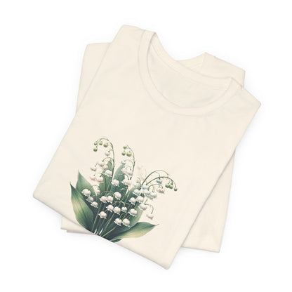 A t-shirt featuring a beautiful Lily of the Valley for May. Perfect for May birthdays and floral art lovers. Comfortable and stylish for casual outings or celebrations. Bella+Canvas 3001 t-shirt in natural. ReadyShirtAim.com