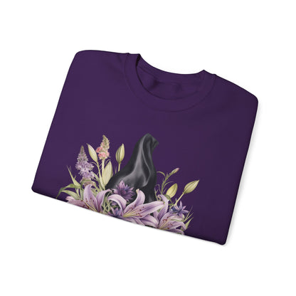 Mystical Floral Witch Hat Sweatshirt featuring a watercolor illustration of a black witch hat with flowers in purple, pink, and green. Available in multiple dark and light colors and sizes. Gildan 18000 sweatshirt in Purple. ReadyShirtAim.com