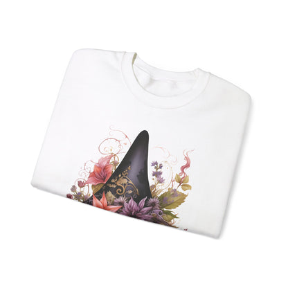 Whimsical Witch Hat Sweatshirt with a watercolor illustration of a black witch hat surrounded by flowers in purple, pink, and green. Available in multiple dark and light colors and sizes. Gildan 18000 sweatshirt in white. ReadyShirtAim.com