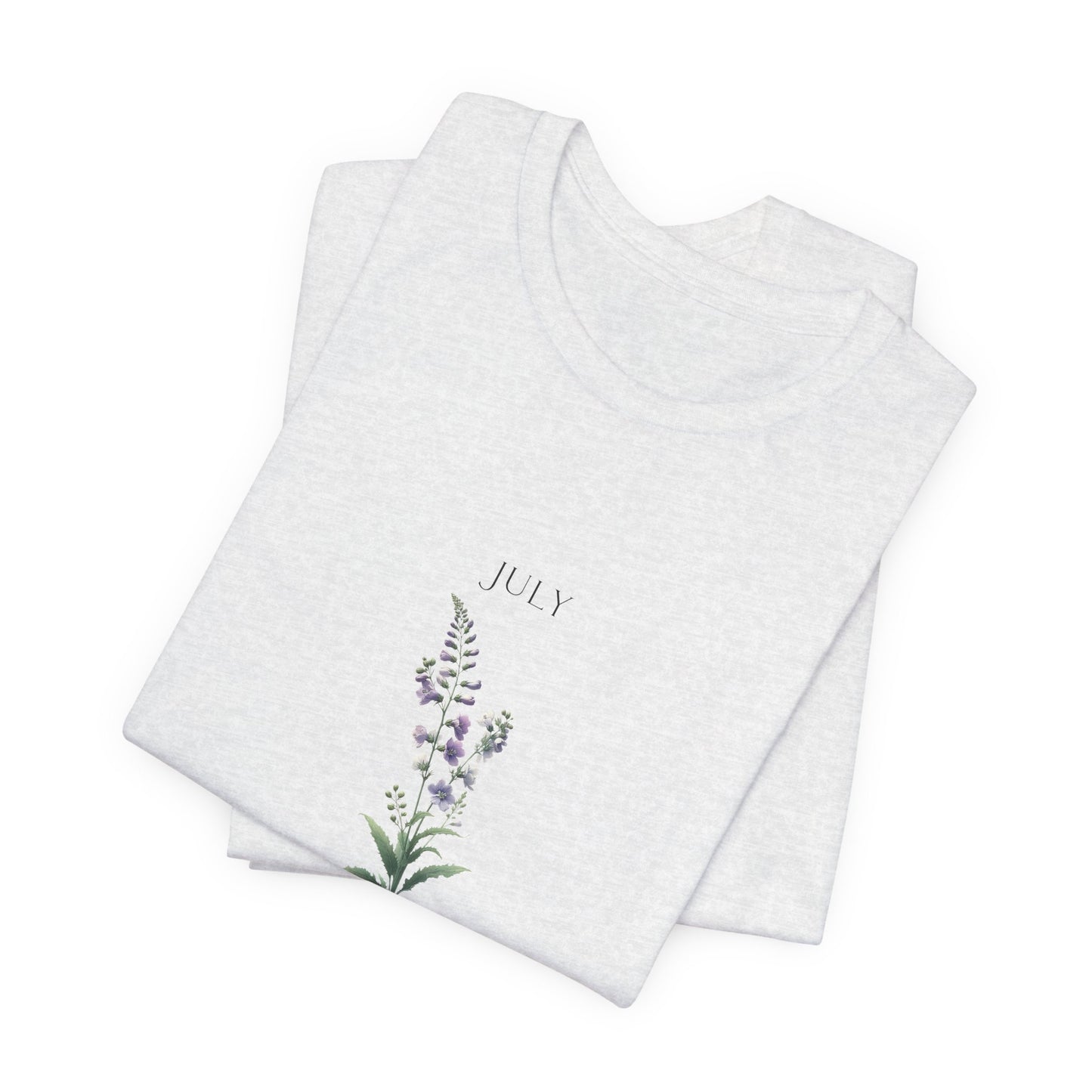 A t-shirt featuring a beautiful larkspur for July with traits Positive, Grace, First Love. Perfect for July birthdays and floral art lovers. Comfortable and stylish for casual outings or celebrations. Bella+Canvas 3001 t-shirt in ash. ReadyShirtAim.com