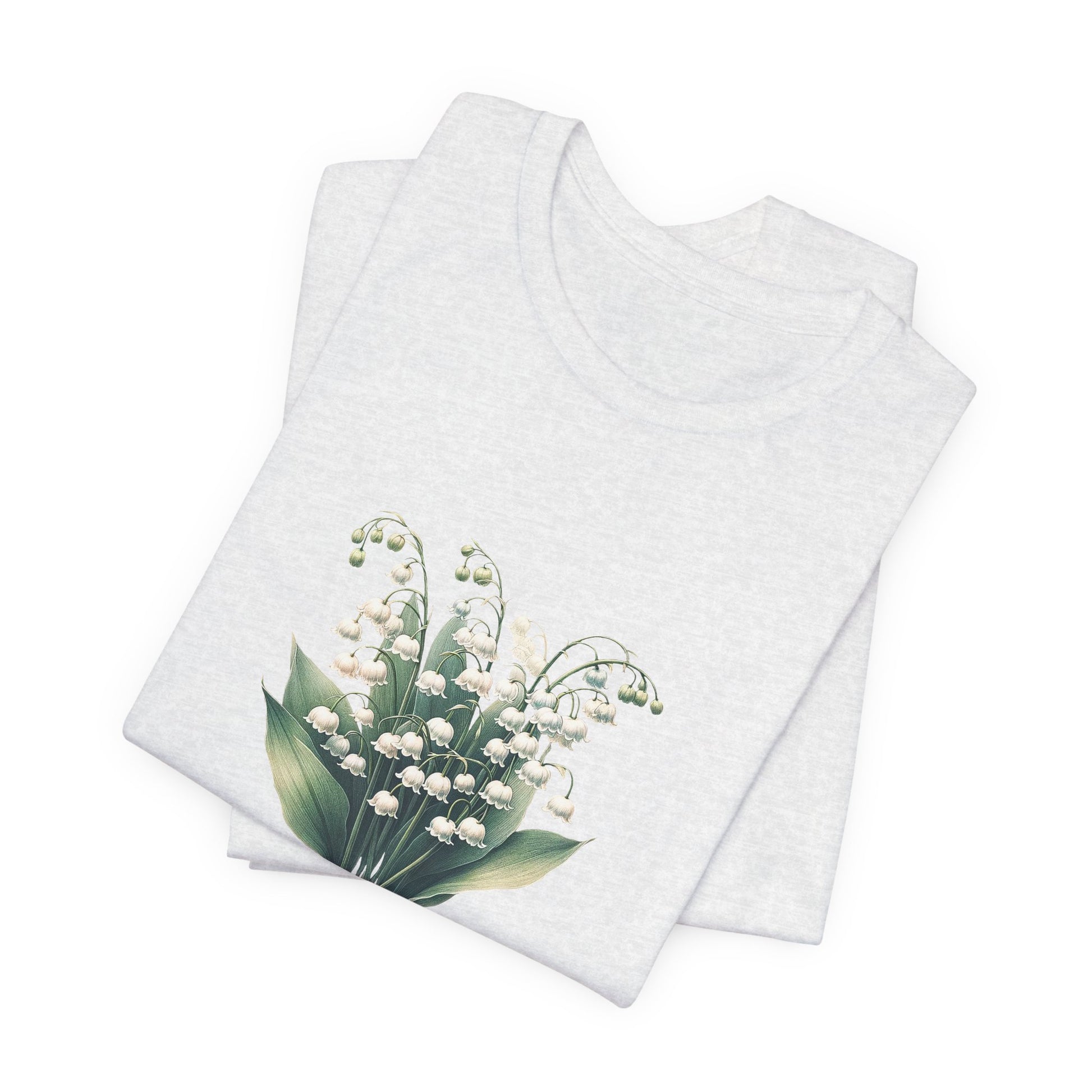 A t-shirt featuring a beautiful Lily of the Valley for May. Perfect for May birthdays and floral art lovers. Comfortable and stylish for casual outings or celebrations. Bella+Canvas 3001 t-shirt in ash. ReadyShirtAim.com