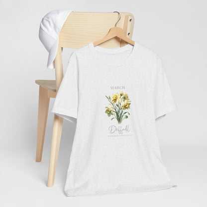 A t-shirt featuring a beautiful daffodil for March with traits New Beginnings, Happiness, Joy. Perfect for March birthdays and floral art lovers. Comfortable and stylish for casual outings or celebrations. Bella+Canvas 3001 t-shirt in ash. ReadyShirtAim.com