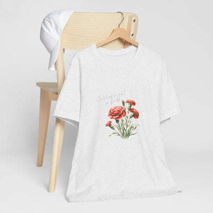 A t-shirt featuring a beautiful carnation for January with the quote “She believed she could, so she did.” Perfect for January birthdays and floral art lovers. Comfortable and stylish for casual outings or celebrations. Bella+Canvas 3001 t-shirt in ash. ReadyShirtAim.com