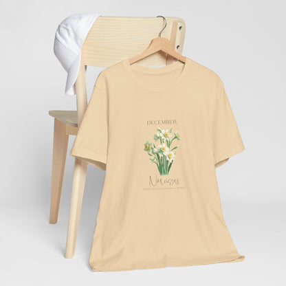 A t-shirt featuring a beautiful narcissus for December with traits Faithfulness, Good Wishes, Respect. Perfect for December birthdays and floral art lovers. Comfortable and stylish for casual outings or celebrations. Bella+Canvas 3001 t-shirt in soft cream. ReadyShirtAim.com