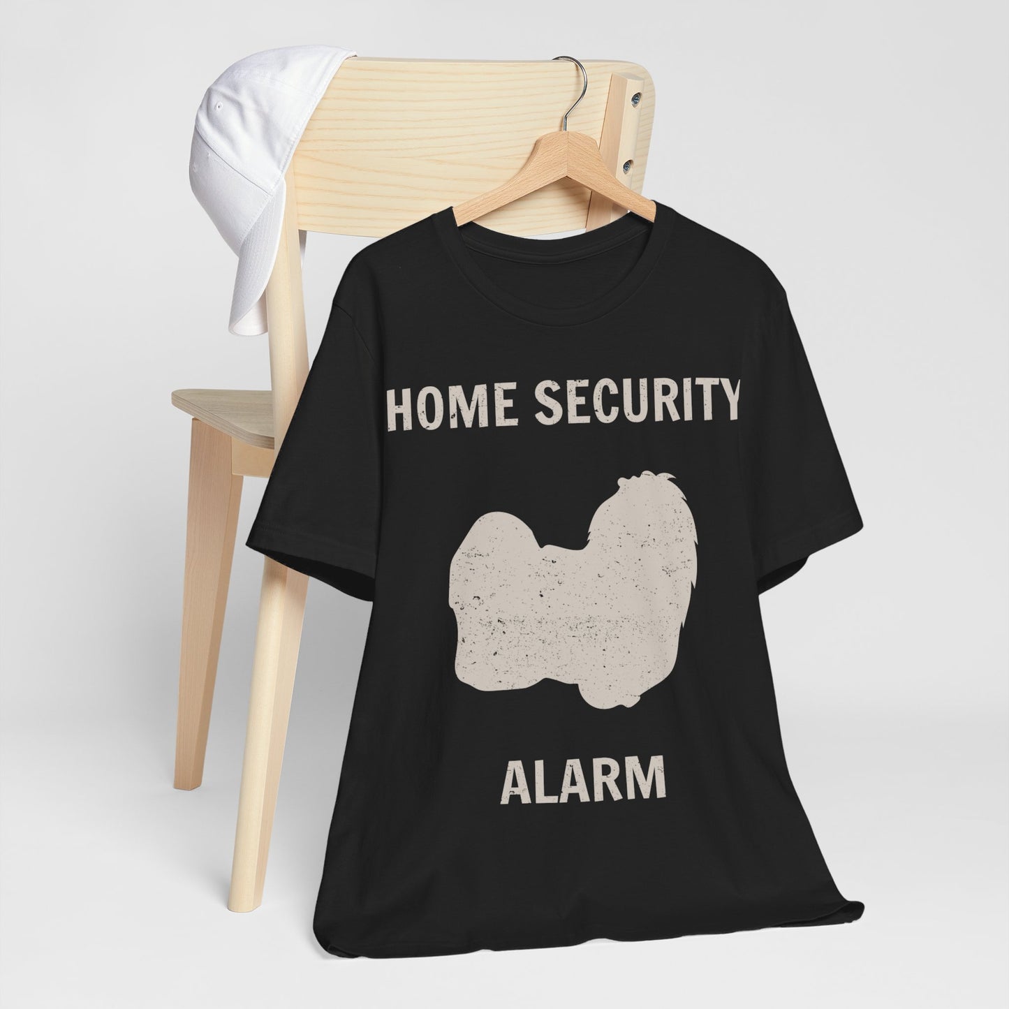 Funny Dog Lovers T-Shirt with an adorable Maltese illustration and "home security alarm" text, perfect for Maltese moms and fur baby parents. Unisex fit for men and women. Available in multiple colors and sizes. Bella+Canvas 3001 t-shirt in dark grey. ReadyShirtAim.com