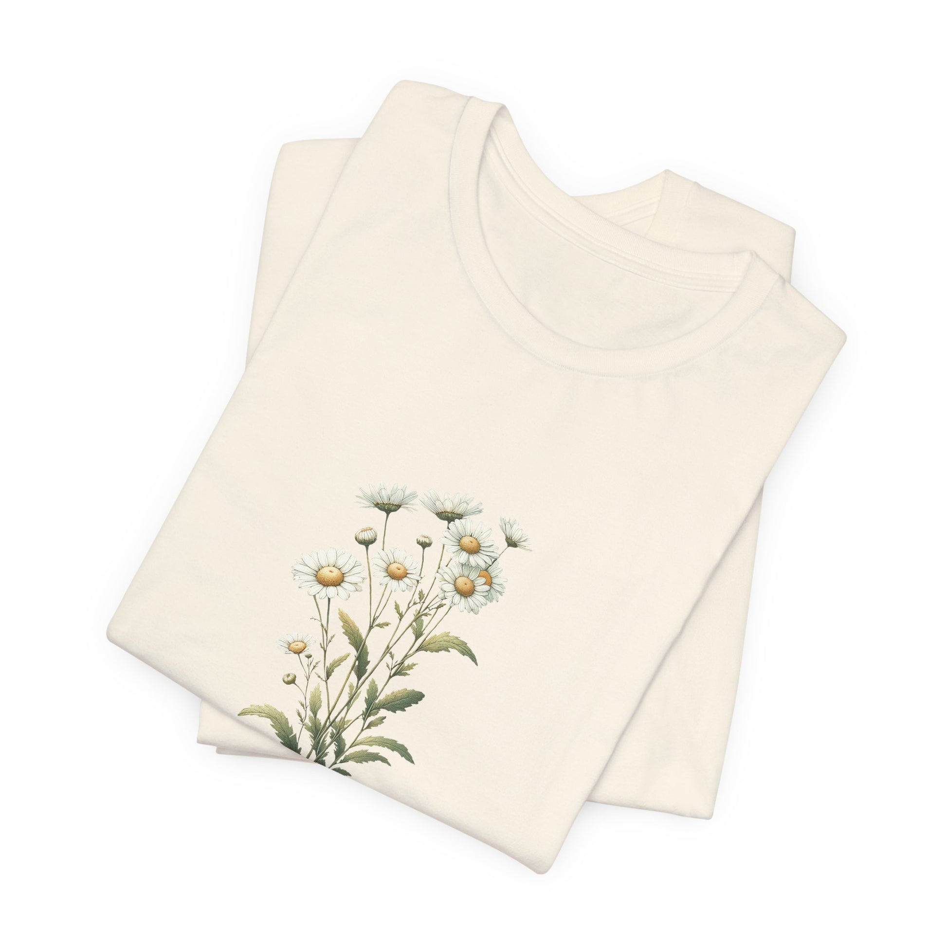 A t-shirt featuring a beautiful daisy for April. Perfect for April birthdays and floral art lovers. Comfortable and stylish for casual outings or celebrations. Bella+Canvas 3001 t-shirt in natural. ReadyShirtAim.com