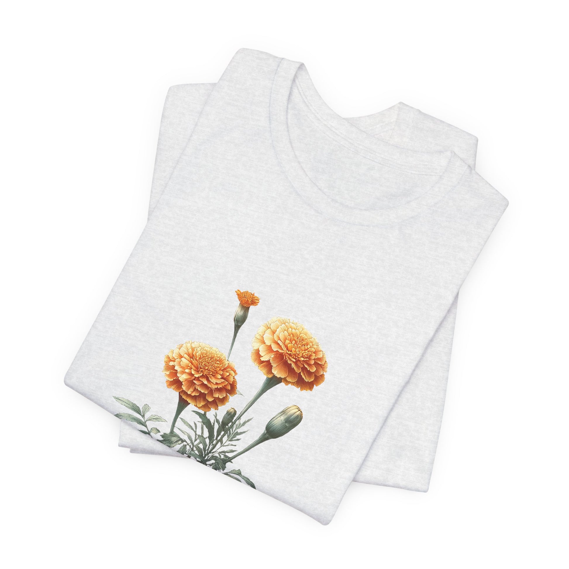 A t-shirt featuring a beautiful marigold for October. Perfect for October birthdays and floral art lovers. Comfortable and stylish for casual outings or celebrations. Bella+Canvas 3001 t-shirt in ash. ReadyShirtAim.com