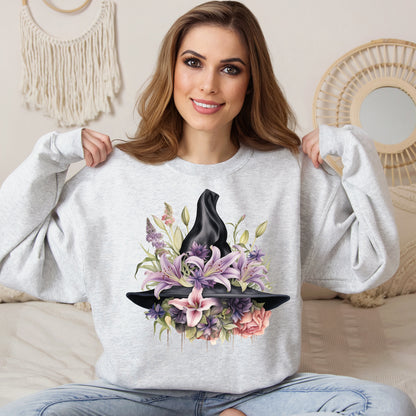 Mystical Floral Witch Hat Sweatshirt featuring a watercolor illustration of a black witch hat with flowers in purple, pink, and green. Available in multiple dark and light colors and sizes. Gildan 18000 sweatshirt in ash. ReadyShirtAim.com