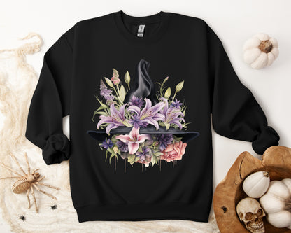 Mystical Floral Witch Hat Sweatshirt featuring a watercolor illustration of a black witch hat with flowers in purple, pink, and green. Available in multiple dark and light colors and sizes. Gildan 18000 sweatshirt in Black. ReadyShirtAim.com