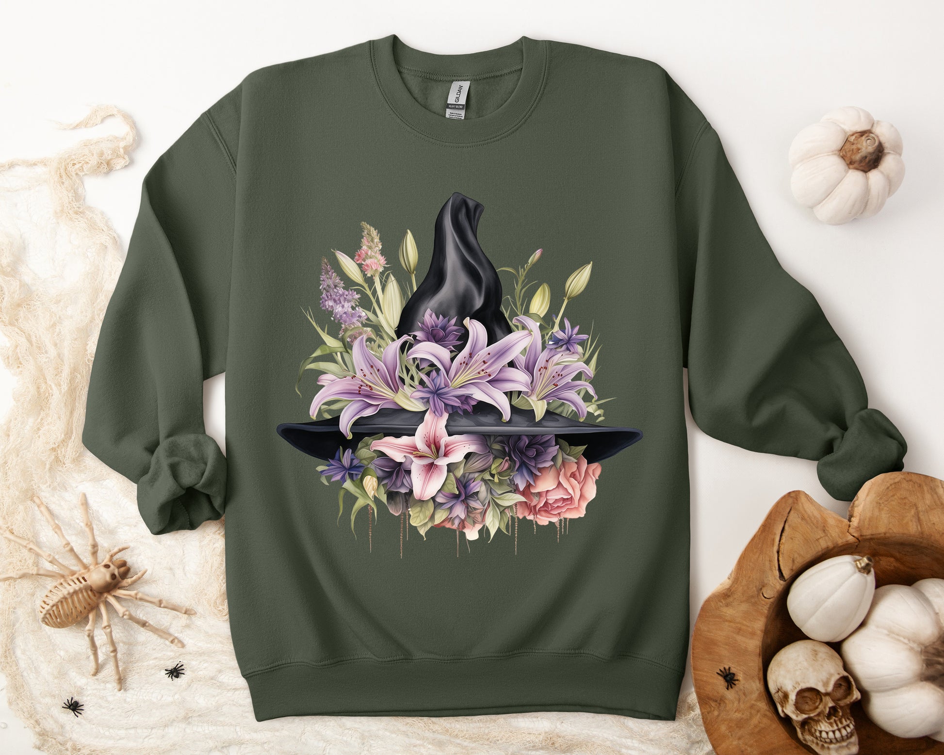 Mystical Floral Witch Hat Sweatshirt featuring a watercolor illustration of a black witch hat with flowers in purple, pink, and green. Available in multiple dark and light colors and sizes. Gildan 18000 sweatshirt in Military Green. ReadyShirtAim.com