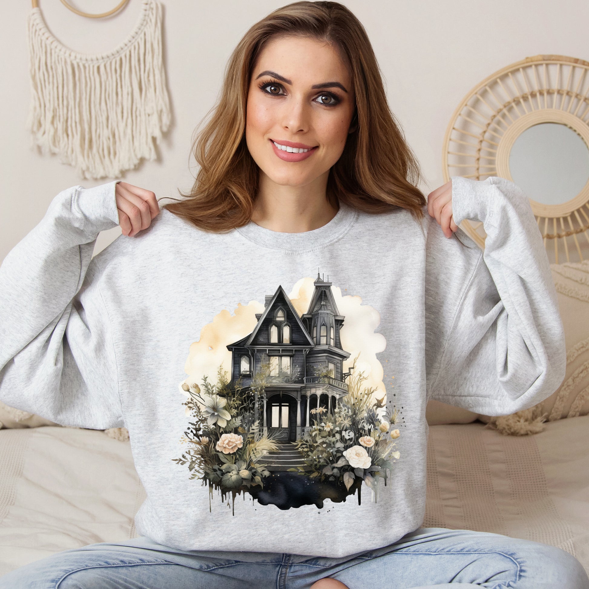 Halloween Boho Sweatshirt for Women featuring a mystical midnight haunted house illustration with boho design accents. Perfect for autumn festivities and casual wear. Available in multiple dark and light colors and sizes. Gildan 18000 sweatshirt in Ash. ReadyShirtAim.com