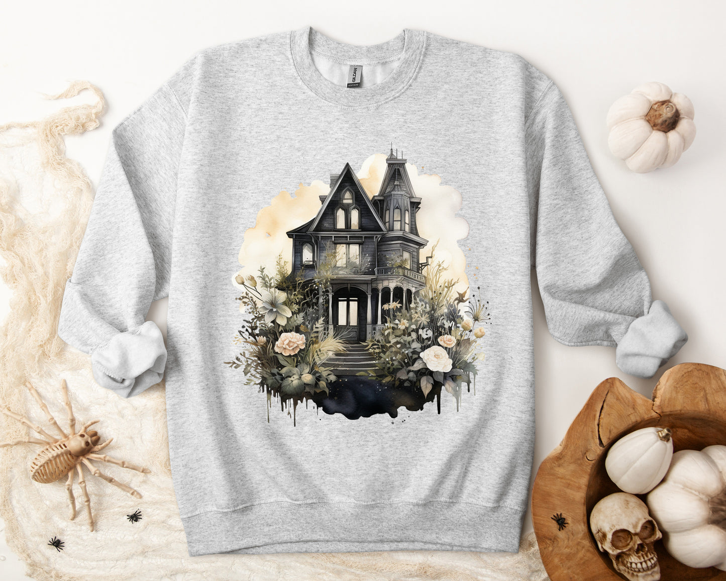 Halloween Boho Sweatshirt for Women featuring a mystical midnight haunted house illustration with boho design accents. Perfect for autumn festivities and casual wear. Available in multiple dark and light colors and sizes. Gildan 18000 sweatshirt in Ash. ReadyShirtAim.com