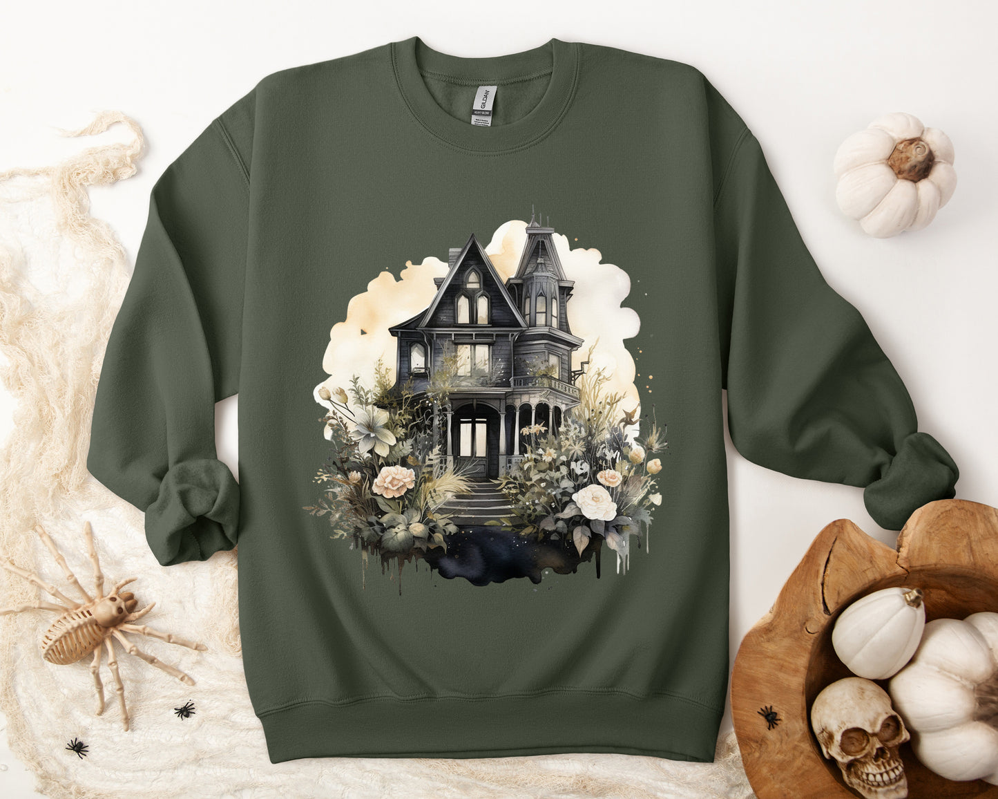 Halloween Boho Sweatshirt for Women featuring a mystical midnight haunted house illustration with boho design accents. Perfect for autumn festivities and casual wear. Gildan 18000 sweatshirt in Military Green. ReadyShirtAim.com