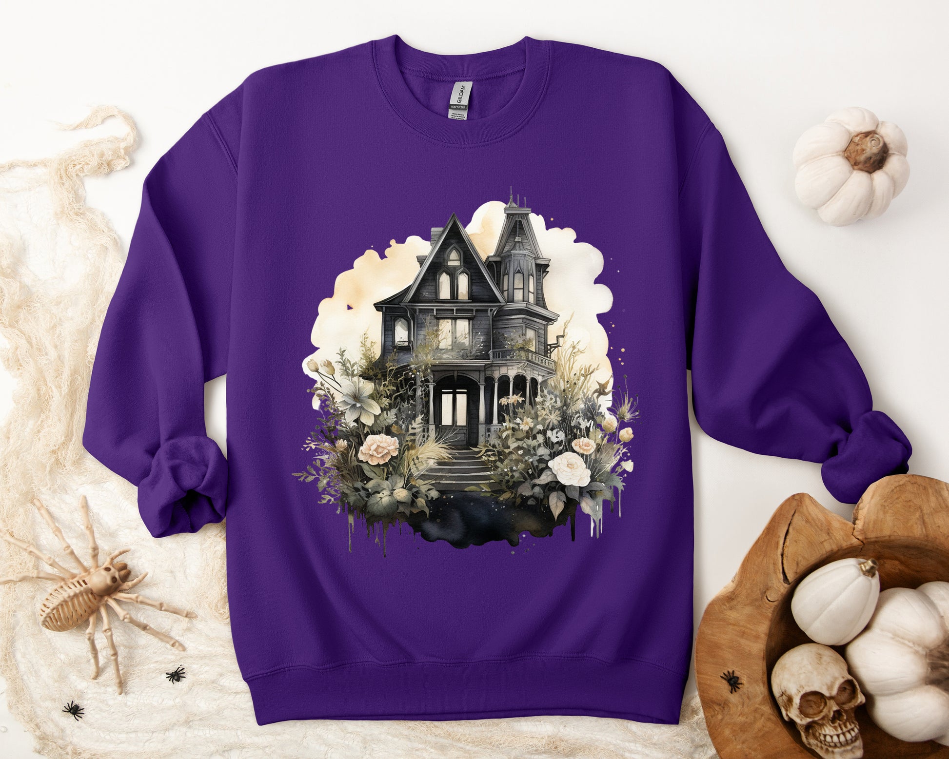 Halloween Boho Sweatshirt for Women featuring a mystical midnight haunted house illustration with boho design accents. Perfect for autumn festivities and casual wear. Gildan 18000 sweatshirt in Purple. ReadyShirtAim.com