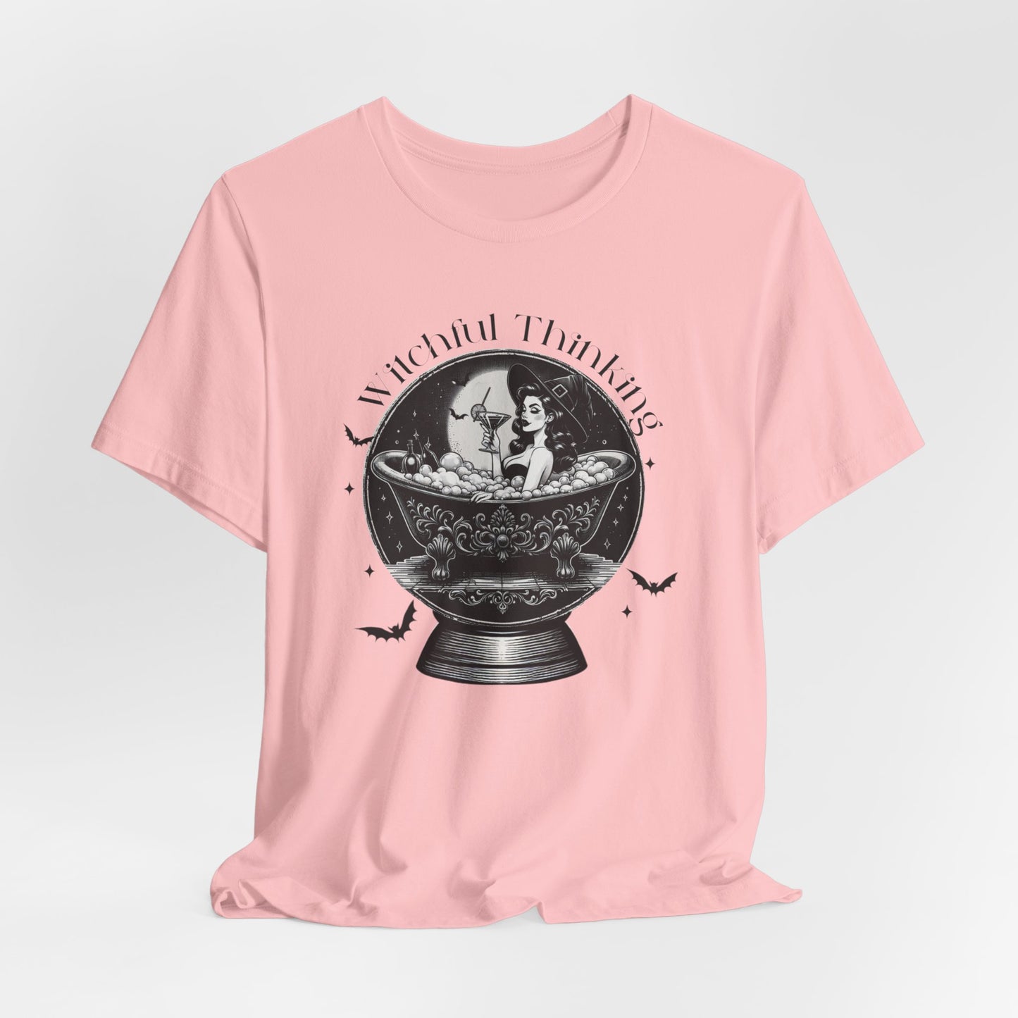 "Witchful Thinking" Vintage 1950's Witch Halloween Women's T-Shirt featuring black text and classic black-and-white pin-up girl images, perfect for adding a retro touch to your Halloween festivities. Available in multiple colors and sizes.  Bella+Canvas 3001 t-shirt in pink. ReadyShirtAim.com