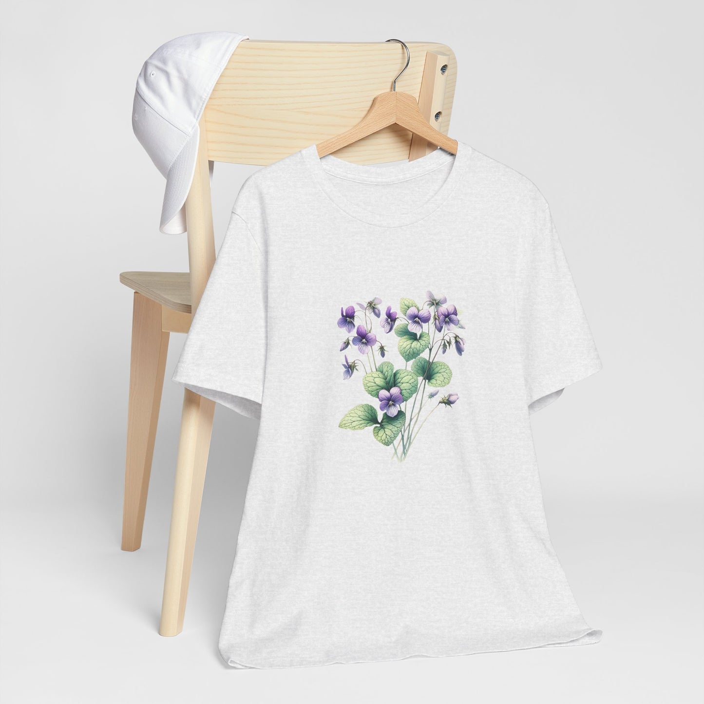 A t-shirt featuring a beautiful violet for February. Perfect for February birthdays and floral art lovers. Comfortable and stylish for casual outings or celebrations. Bella+Canvas 3001 t-shirt in ash. ReadyShirtAim.com