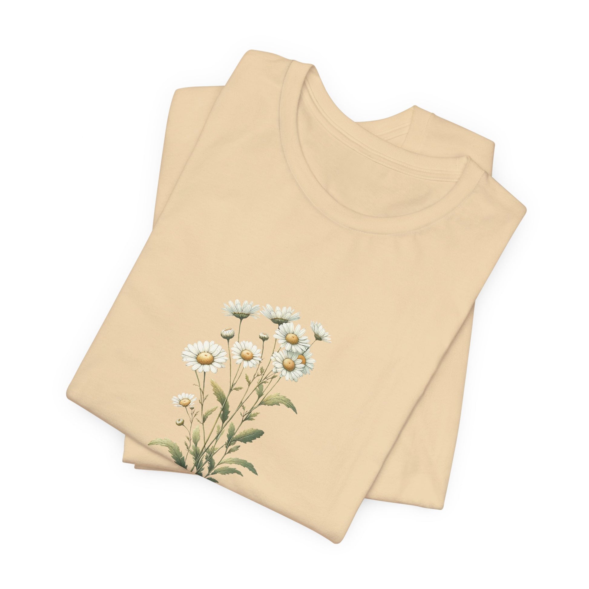 A t-shirt featuring a beautiful daisy for April. Perfect for April birthdays and floral art lovers. Comfortable and stylish for casual outings or celebrations. Bella+Canvas 3001 t-shirt in soft cream. ReadyShirtAim.com