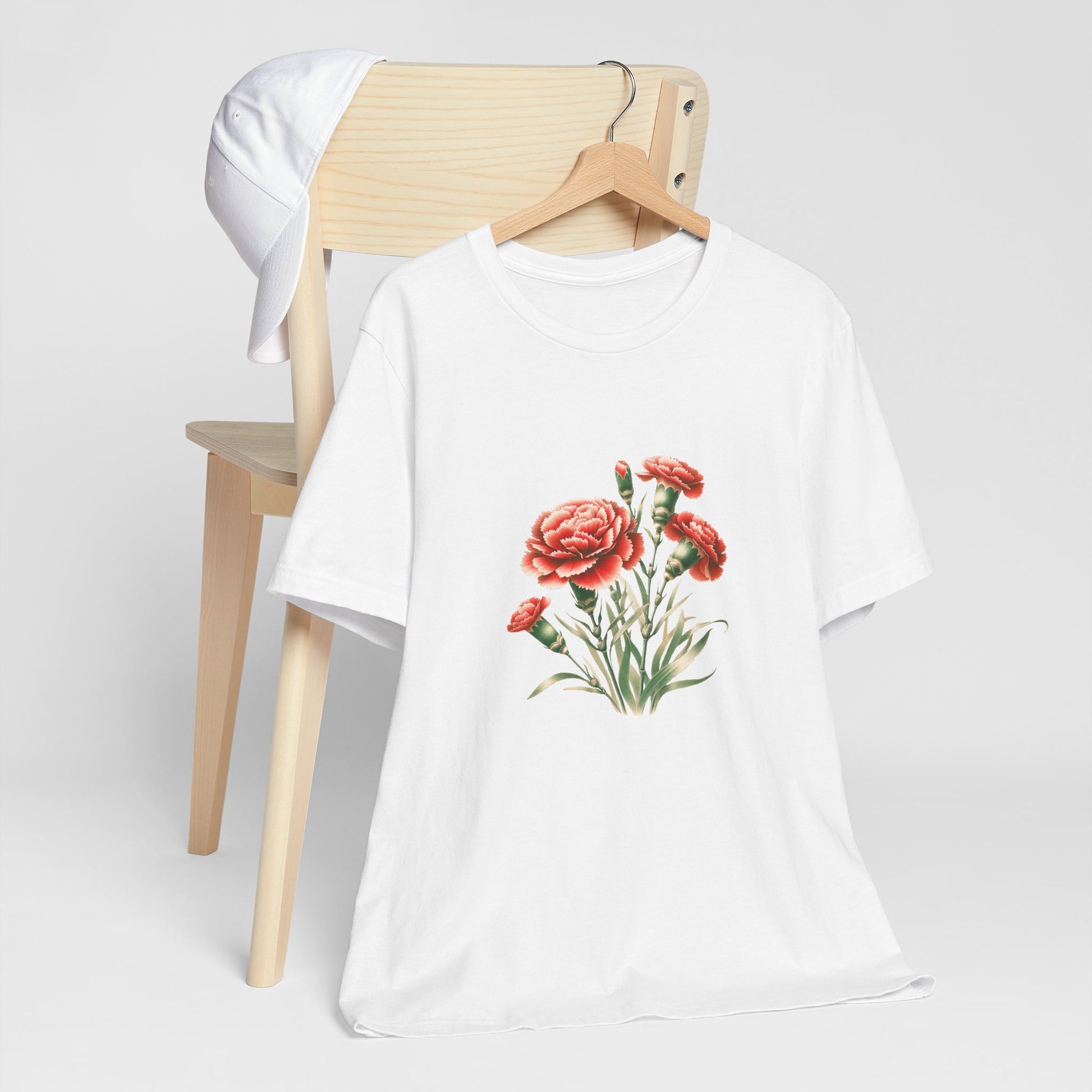 A t-shirt featuring a beautiful carnation for January. Perfect for January birthdays and floral art lovers. Comfortable and stylish for casual outings or celebrations. Bella+Canvas 3001 t-shirt in white. ReadyShirtAim.com