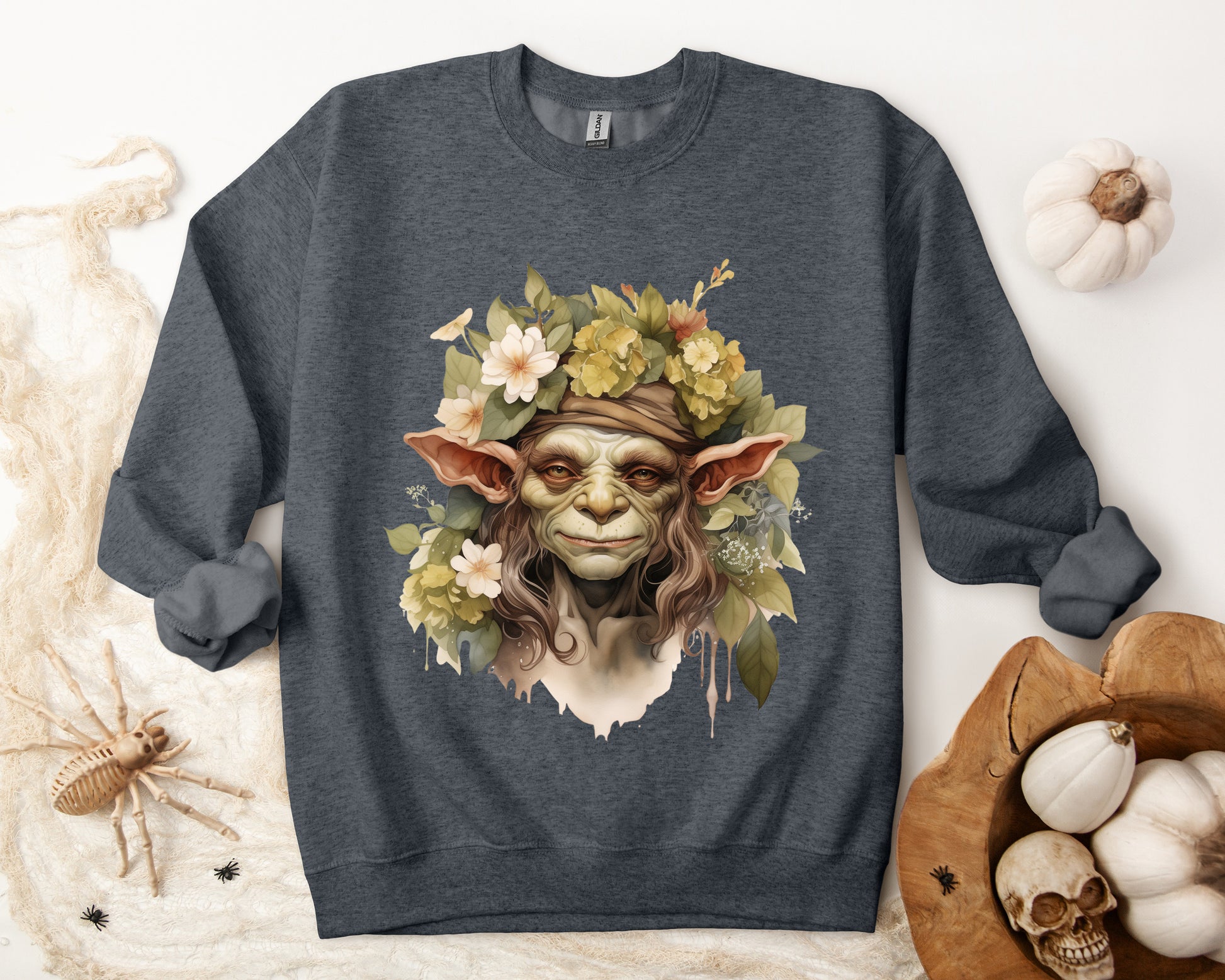 Creepy Cute Goblin Floral Boho Halloween Sweatshirt for women. Features a charming goblin surrounded by muted florals. Perfect for Halloween celebrations. Available in multiple dark and light colors and sizes. Gildan 18000 sweatshirt in Dark Grey Heather. ReadyShirtAim.com