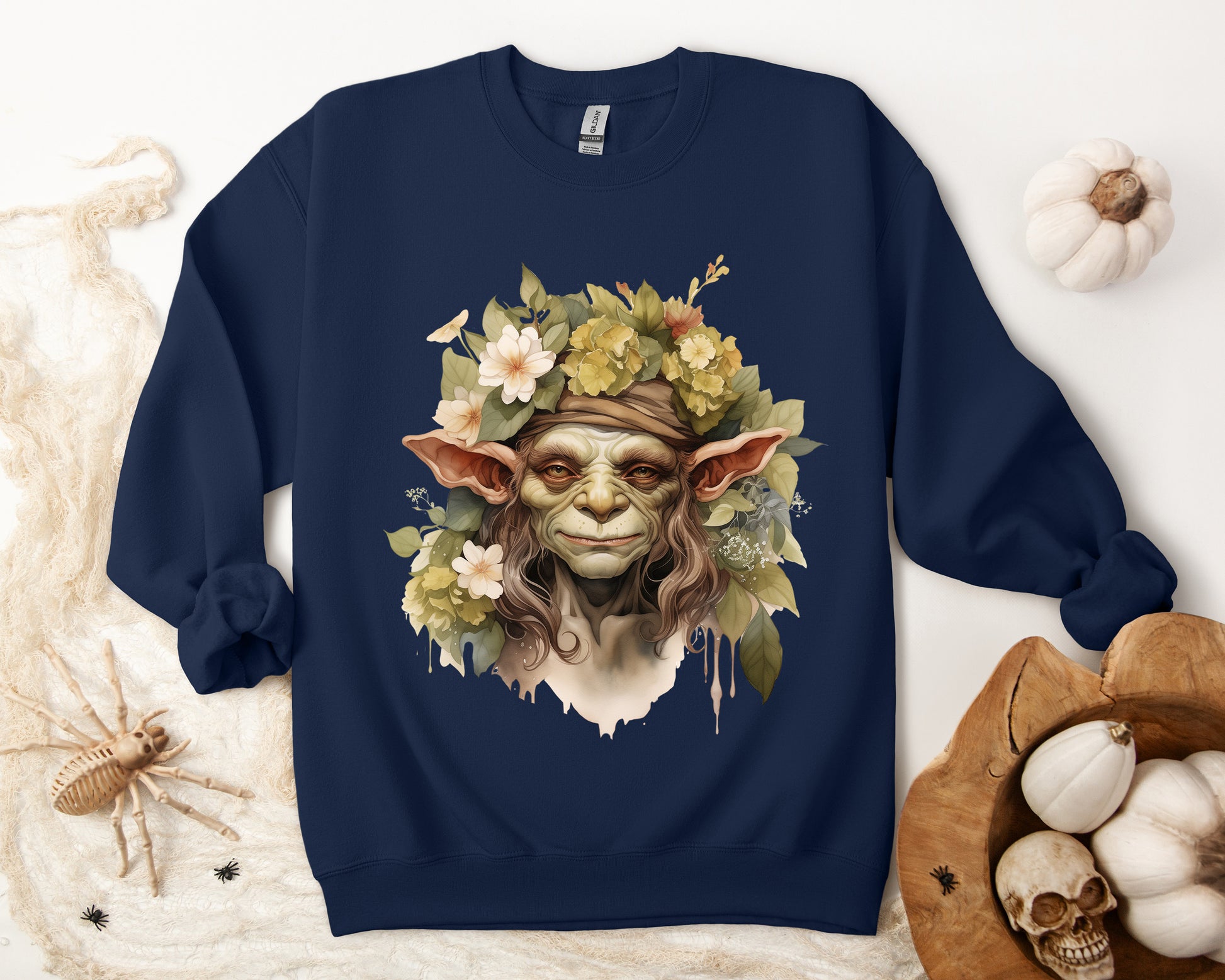 Creepy Cute Goblin Floral Boho Halloween Sweatshirt for women. Features a charming goblin surrounded by muted florals. Perfect for Halloween celebrations. Available in multiple dark and light colors and sizes. Gildan 18000 sweatshirt in Navy. ReadyShirtAim.com