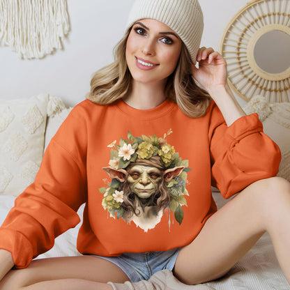 Creepy Cute Goblin Floral Boho Halloween Sweatshirt for women. Features a charming goblin surrounded by muted florals. Perfect for Halloween celebrations. Available in multiple dark and light colors and sizes. Gildan 18000 sweatshirt in Orange. ReadyShirtAim.com