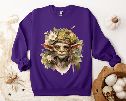 Creepy Cute Goblin Floral Boho Halloween Sweatshirt for women. Features a charming goblin surrounded by muted florals. Perfect for Halloween celebrations. Available in multiple dark and light colors and sizes. Gildan 18000 sweatshirt in Purple. ReadyShirtAim.com