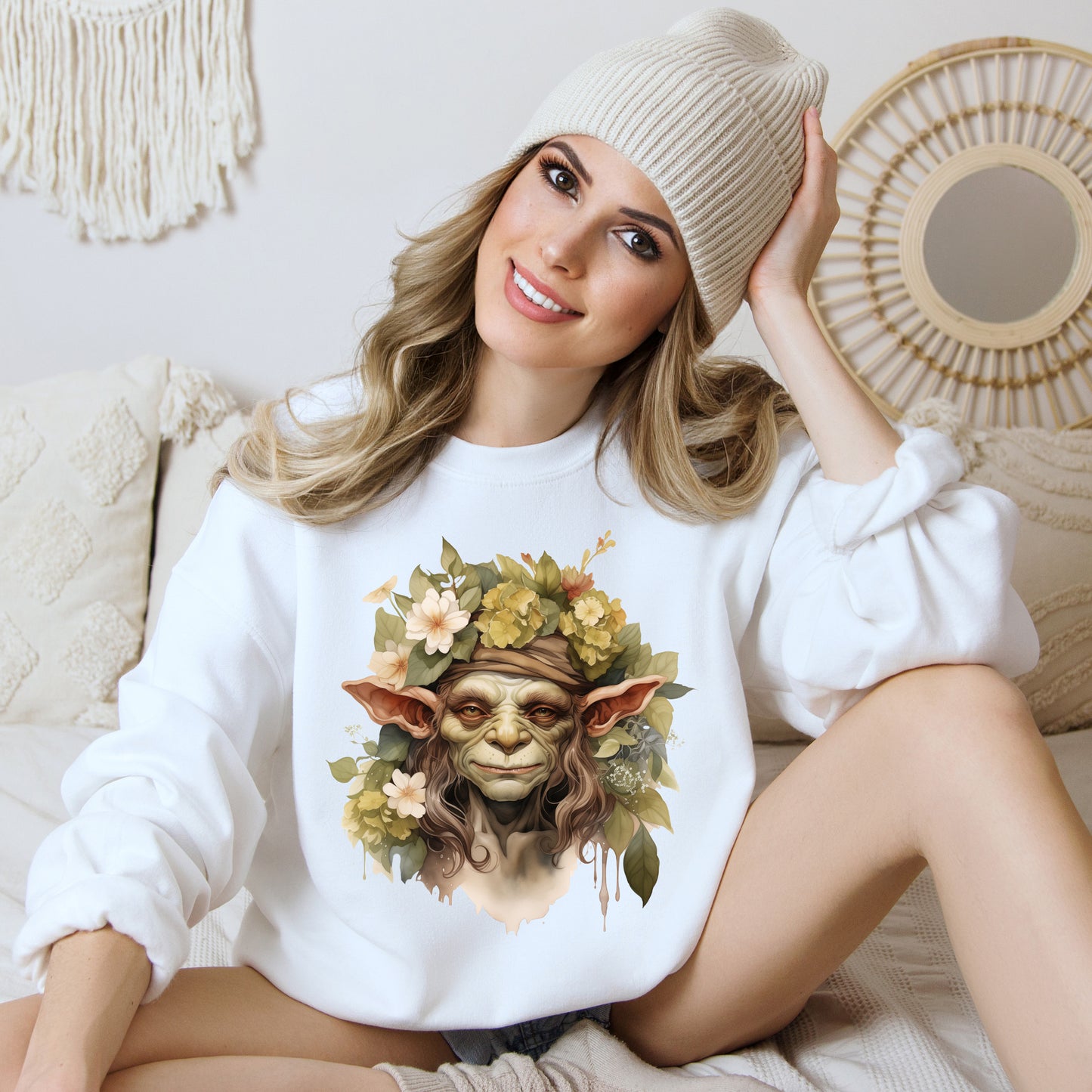 Creepy Cute Goblin Floral Boho Halloween Sweatshirt for women. Features a charming goblin surrounded by muted florals. Perfect for Halloween celebrations. Available in multiple dark and light colors and sizes. Gildan 18000 sweatshirt in white. ReadyShirtAim.com