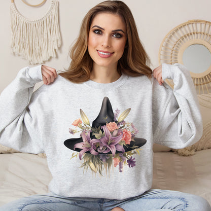 Elegant Witchy Blooms Sweatshirt with a watercolor illustration of a black witch hat and flowers in purple, pink, and green. Available in multiple dark and light colors and sizes. Gildan 18000 sweatshirt in ash. ReadyShirtAim.com