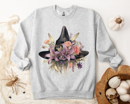 Elegant Witchy Blooms Sweatshirt with a watercolor illustration of a black witch hat and flowers in purple, pink, and green. Available in multiple dark and light colors and sizes. Gildan 18000 sweatshirt in ash. ReadyShirtAim.com