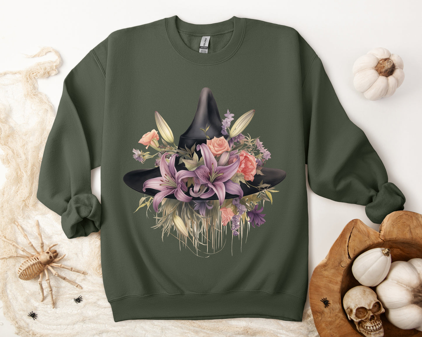 Elegant Witchy Blooms Sweatshirt with a watercolor illustration of a black witch hat and flowers in purple, pink, and green. Available in multiple dark and light colors and sizes. Gildan 18000 sweatshirt in Military Green. ReadyShirtAim.com