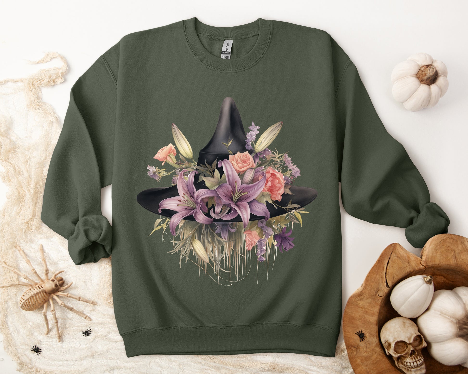 Elegant Witchy Blooms Sweatshirt with a watercolor illustration of a black witch hat and flowers in purple, pink, and green. Available in multiple dark and light colors and sizes. Gildan 18000 sweatshirt in Military Green. ReadyShirtAim.com