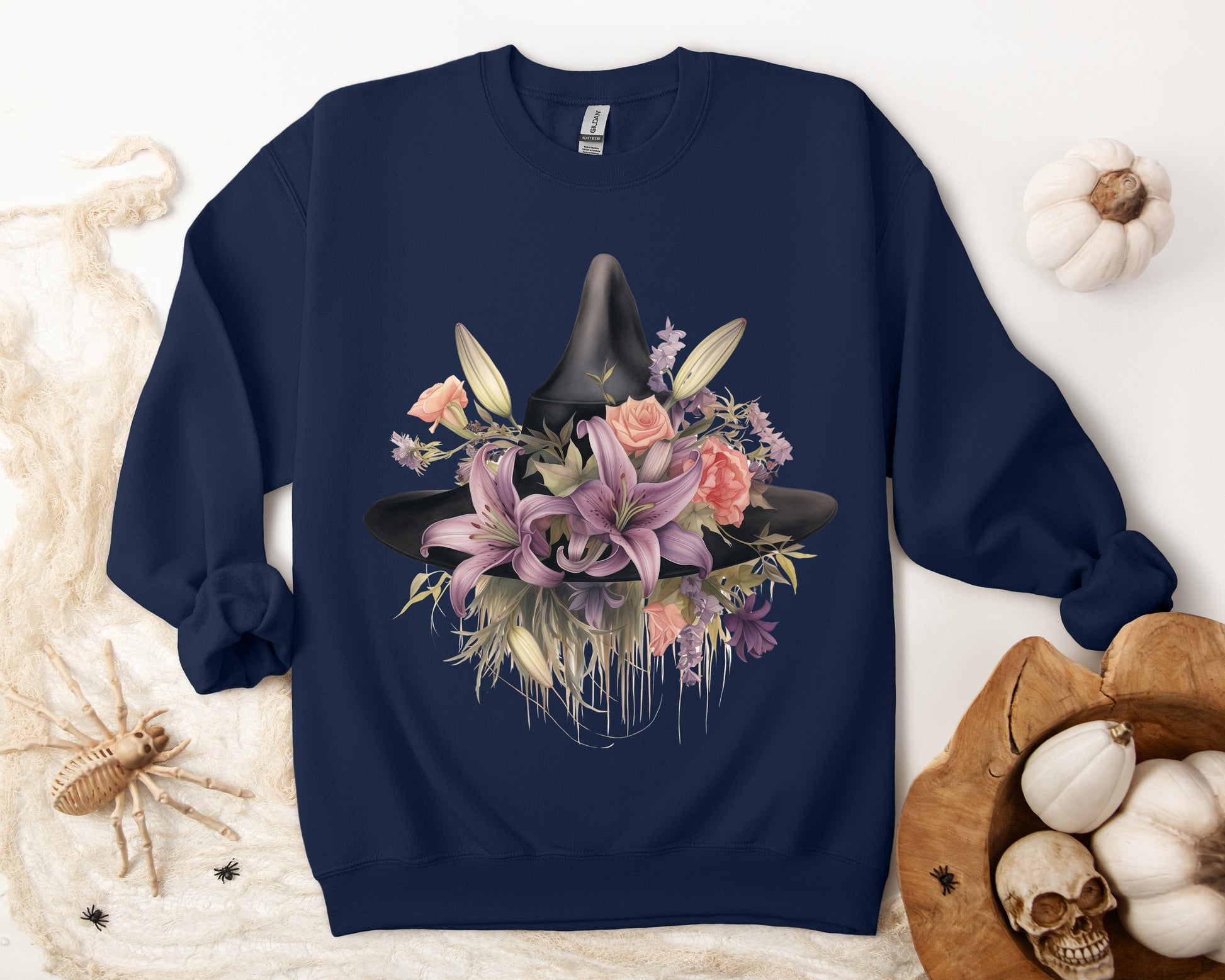 Elegant Witchy Blooms Sweatshirt with a watercolor illustration of a black witch hat and flowers in purple, pink, and green. Available in multiple dark and light colors and sizes. Gildan 18000 sweatshirt in Navy. ReadyShirtAim.com