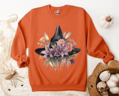 Elegant Witchy Blooms Sweatshirt with a watercolor illustration of a black witch hat and flowers in purple, pink, and green. Available in multiple dark and light colors and sizes. Gildan 18000 sweatshirt in Orange. ReadyShirtAim.com