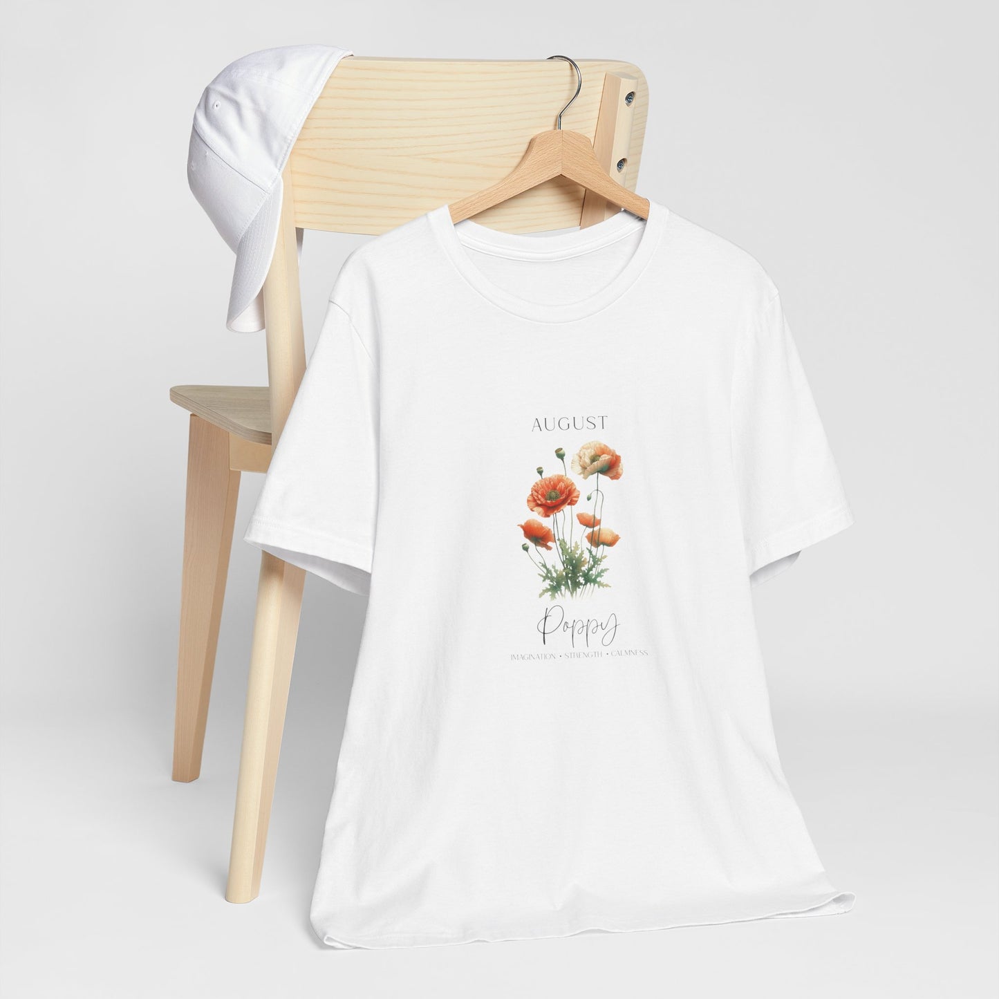 A t-shirt featuring a beautiful poppy for August with traits Imagination, Strength, Calmness. Perfect for August birthdays and floral art lovers. Comfortable and stylish for casual outings or celebrations. Bella+Canvas 3001 t-shirt in white. ReadyShirtAim.com