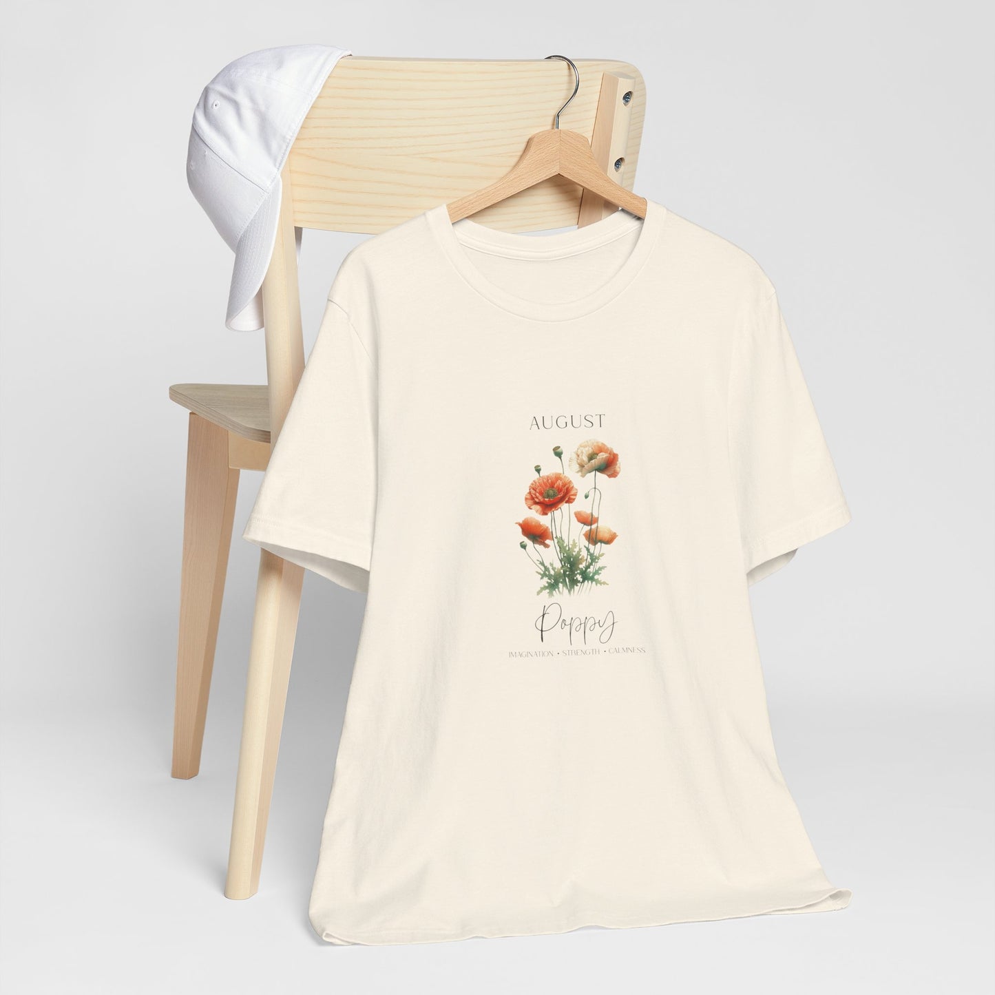 A t-shirt featuring a beautiful poppy for August with traits Imagination, Strength, Calmness. Perfect for August birthdays and floral art lovers. Comfortable and stylish for casual outings or celebrations. Bella+Canvas 3001 t-shirt in natural. ReadyShirtAim.com