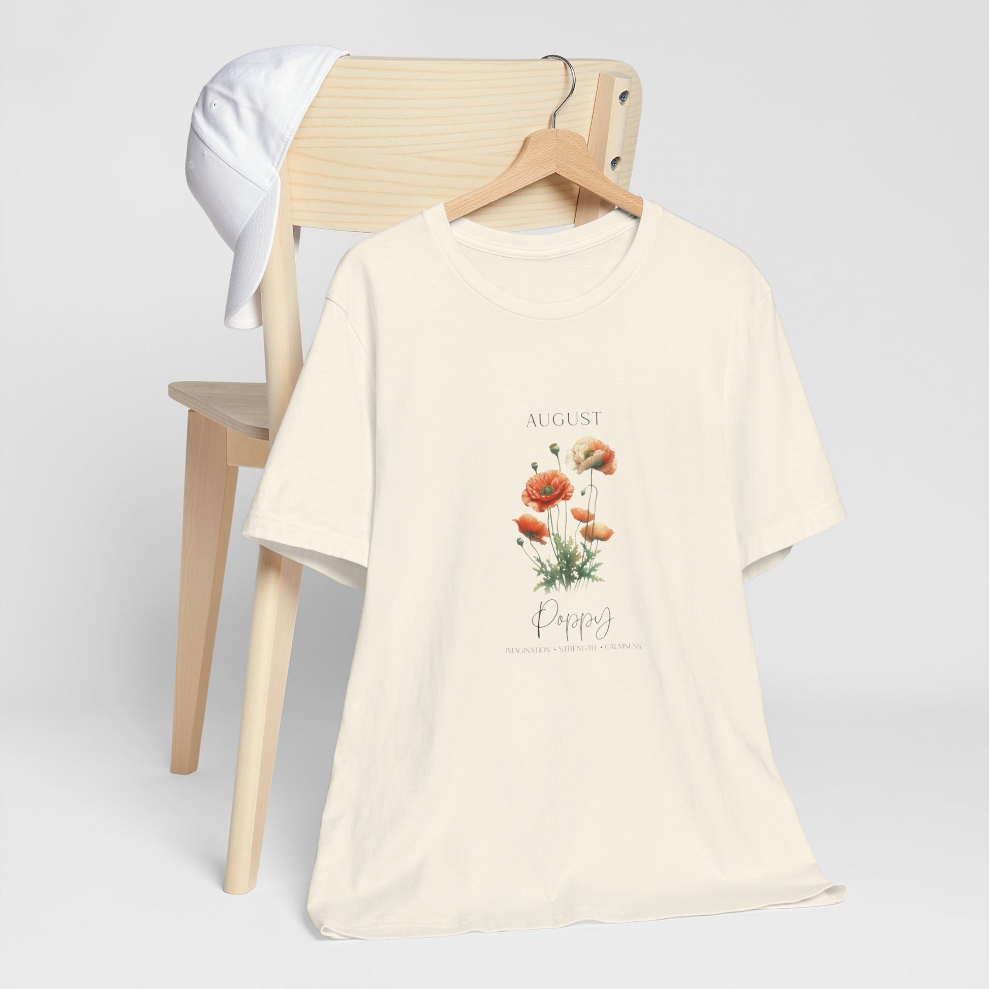 A t-shirt featuring a beautiful poppy for August with traits Imagination, Strength, Calmness. Perfect for August birthdays and floral art lovers. Comfortable and stylish for casual outings or celebrations. Bella+Canvas 3001 t-shirt in natural. ReadyShirtAim.com