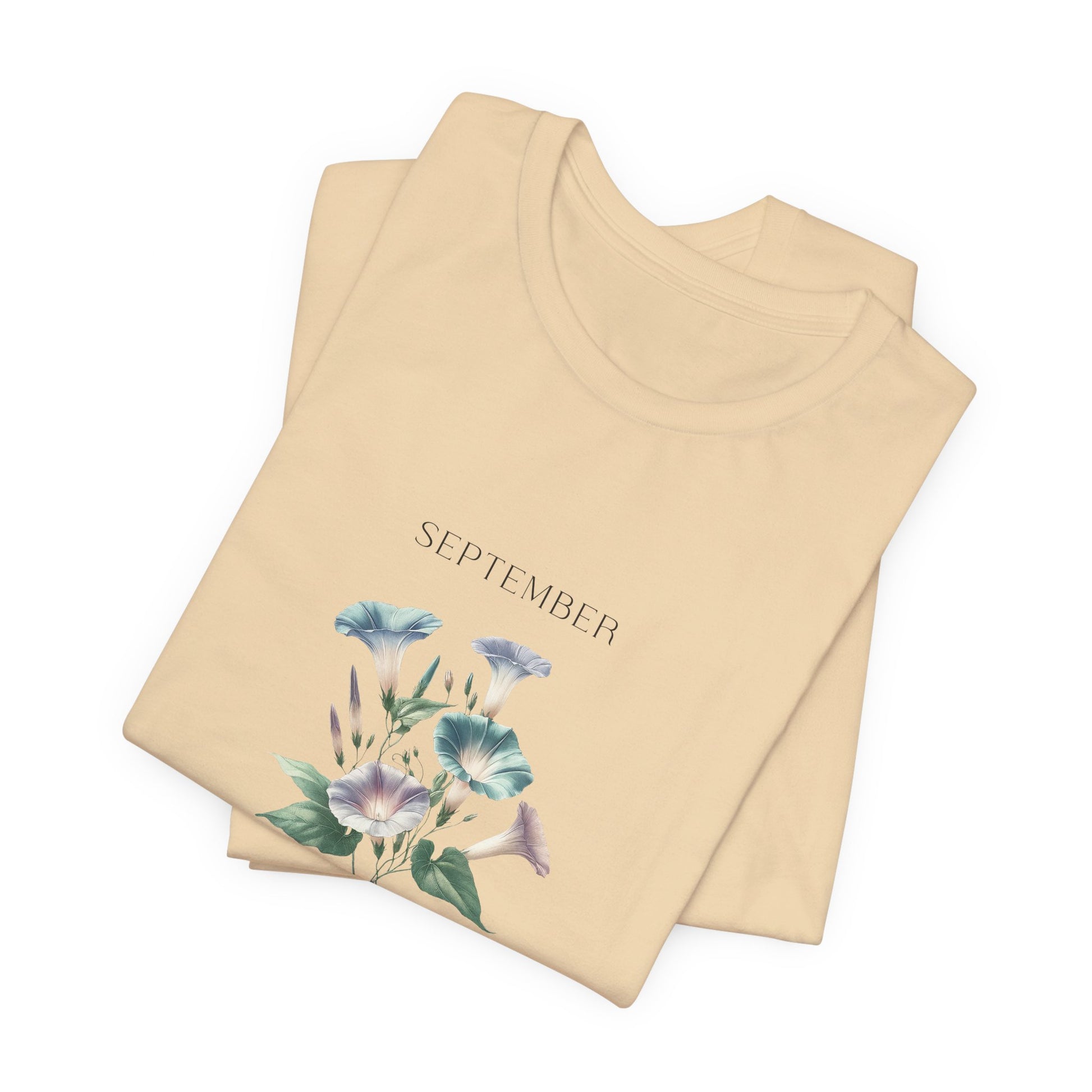 A t-shirt featuring a beautiful morning glory for September with traits Love, Affection, Mortality. Perfect for September birthdays and floral art lovers. Comfortable and stylish for casual outings or celebrations. Bella+Canvas 3001 t-shirt in soft cream. ReadyShirtAim.com