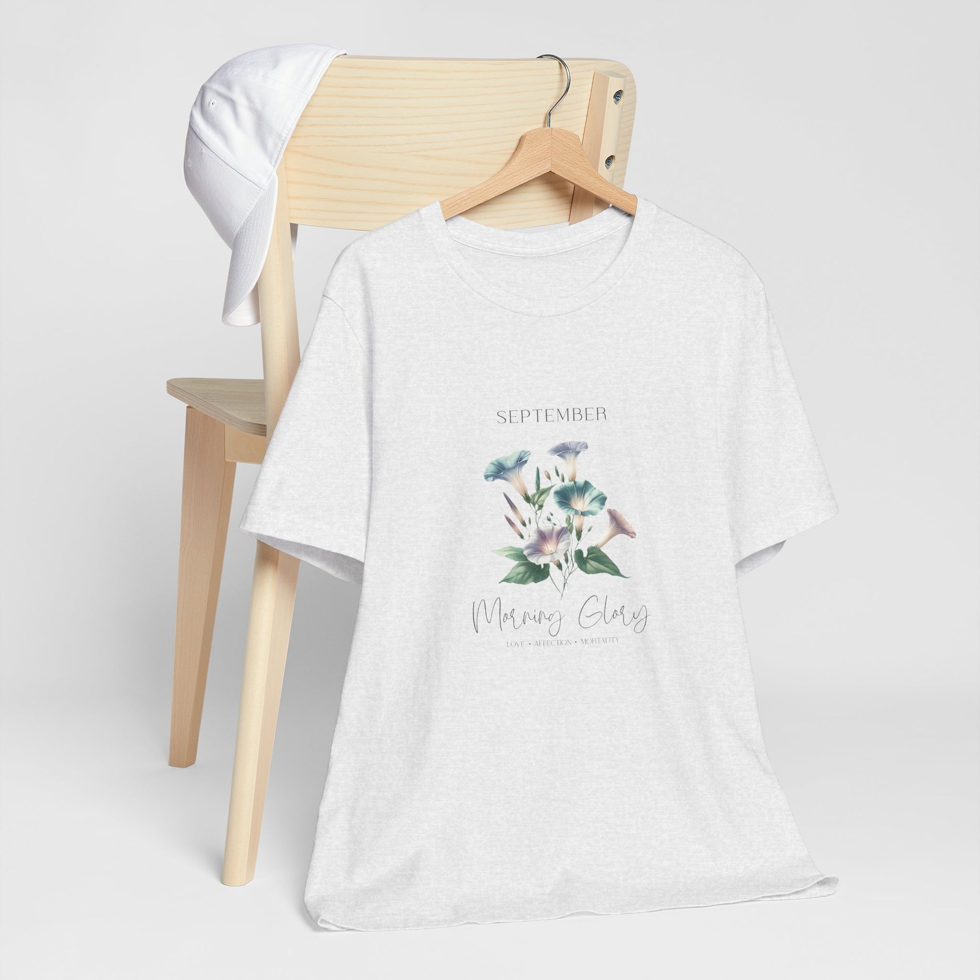 A t-shirt featuring a beautiful morning glory for September with traits Love, Affection, Mortality. Perfect for September birthdays and floral art lovers. Comfortable and stylish for casual outings or celebrations. Bella+Canvas 3001 t-shirt in ash. ReadyShirtAim.com