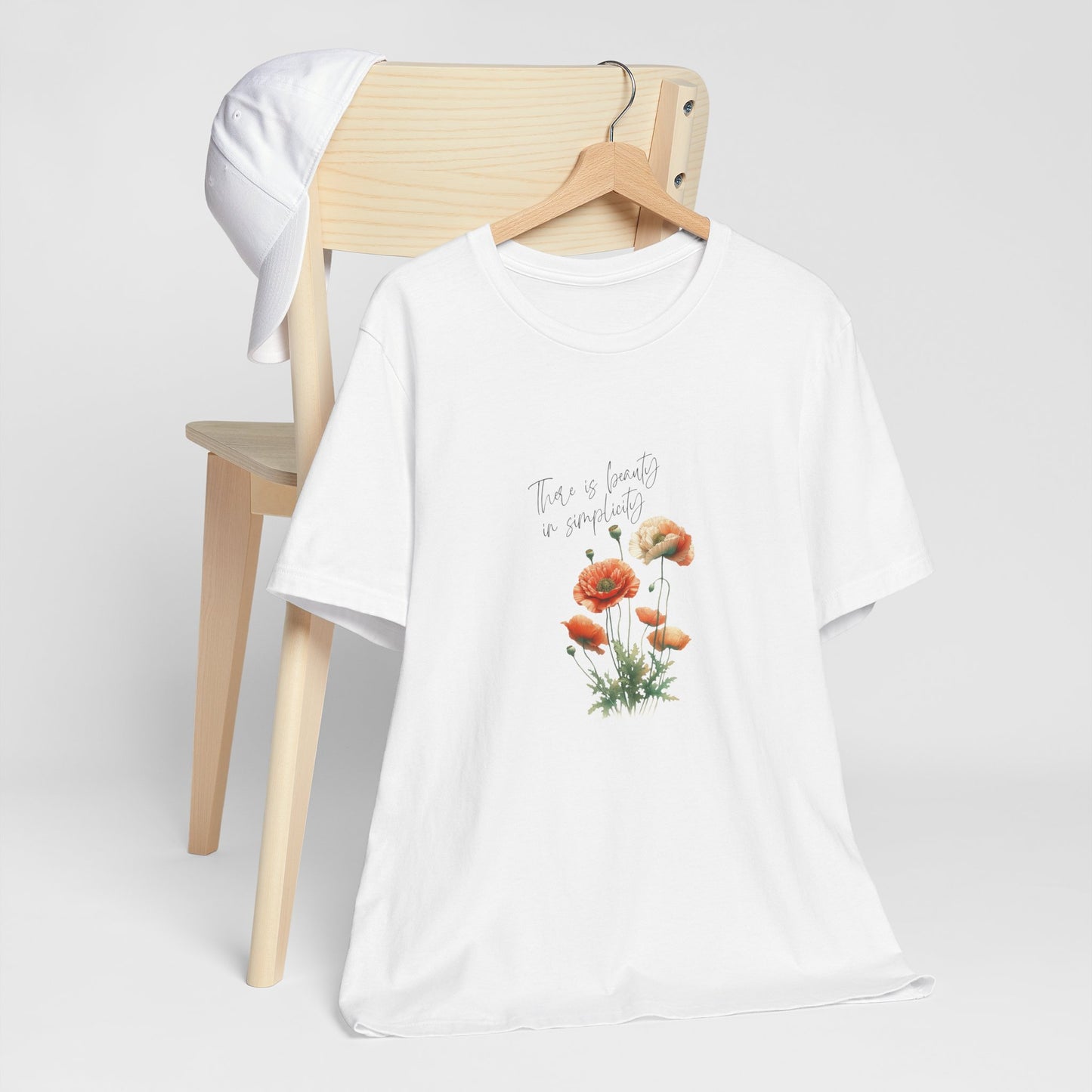 A t-shirt featuring a beautiful poppy for August with the quote “There is beauty in simplicity.” Perfect for August birthdays and floral art lovers. Comfortable and stylish for casual outings or celebrations. Bella+Canvas 3001 t-shirt in white. ReadyShirtAim.com