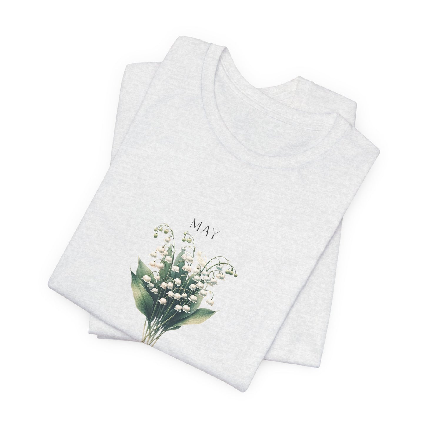 A t-shirt featuring a beautiful Lily of the Valley for May with traits Motherhood, Sweetness, Purity. Perfect for May birthdays and floral art lovers. Comfortable and stylish for casual outings or celebrations. Bella+Canvas 3001 t-shirt in ash. ReadyShirtAim.com