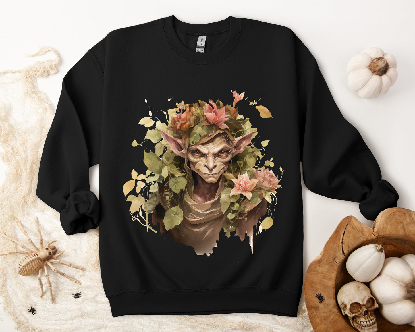 Boho Goblin Magic Halloween Sweatshirt for women. Features a charming goblin surrounded by muted florals. Perfect for Halloween celebrations. Available in multiple dark and light colors and sizes. Gildan 18000 sweatshirt in Black. ReadyShirtAim.com