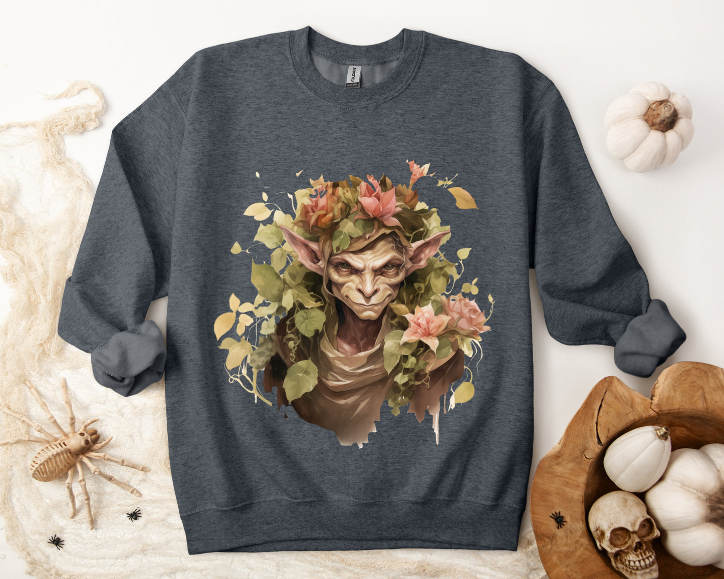 Boho Goblin Magic Halloween Sweatshirt for women. Features a charming goblin surrounded by muted florals. Perfect for Halloween celebrations. Available in multiple dark and light colors and sizes. Gildan 18000 sweatshirt in dark grey heather. ReadyShirtAim.com