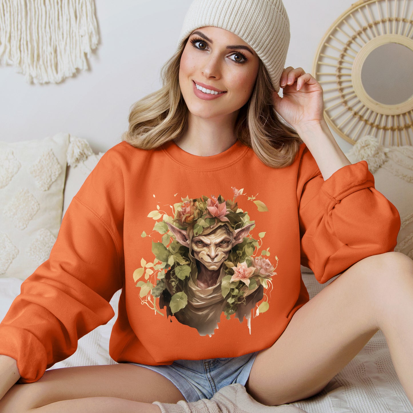 Boho Goblin Magic Halloween Sweatshirt for women. Features a charming goblin surrounded by muted florals. Perfect for Halloween celebrations. Available in multiple dark and light colors and sizes. Gildan 18000 sweatshirt in Orange. ReadyShirtAim.com