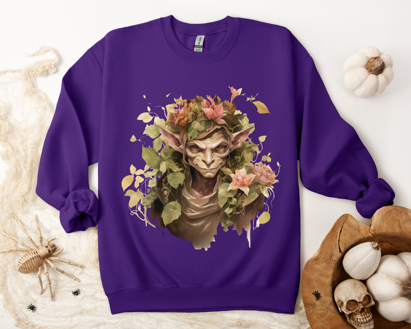 Boho Goblin Magic Halloween Sweatshirt for women. Features a charming goblin surrounded by muted florals. Perfect for Halloween celebrations. Available in multiple dark and light colors and sizes. Gildan 18000 sweatshirt in Purple. ReadyShirtAim.com