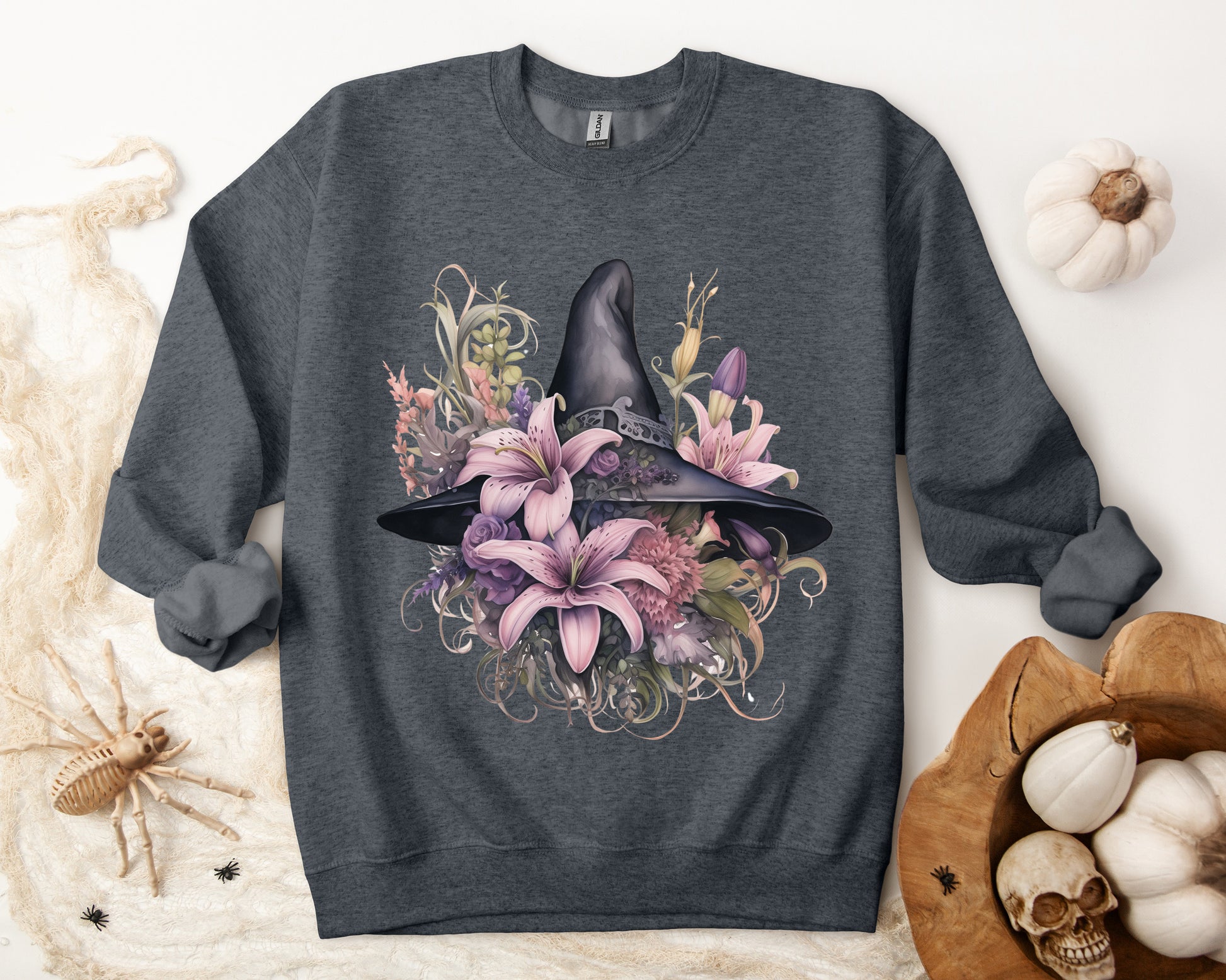 Charming Witch Hat & Flowers Sweatshirt with a watercolor illustration of a black witch hat and flowers in purple, pink, and green. Available in multiple dark and light colors and sizes. Gildan 18000 sweatshirt in Dark Grey Heather. ReadyShirtAim.com